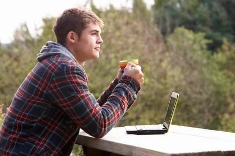 Young man with laptop computer Stock Photos