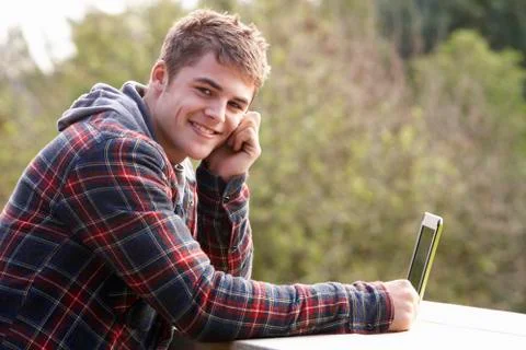 Young man with laptop computer Stock Photos