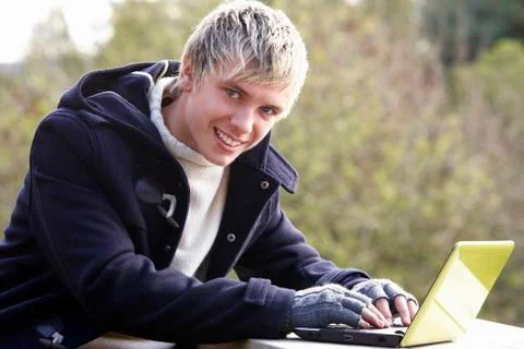 Young man with laptop computer Stock Photos