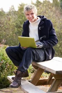 Young man with laptop computer Stock Photos