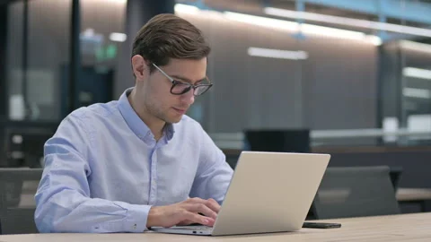 Young Man with Laptop Pointing at the Camera Stock Footage 150642587