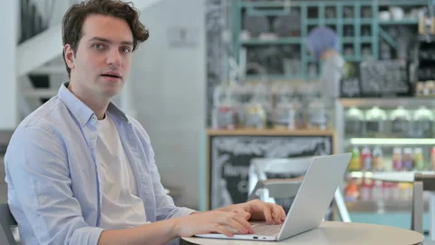 Young Man with Laptop Shaking Head as Yes Sign Video stock 150402831