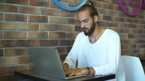 Young man with a laptop work in cafe Stock Footage 67098914