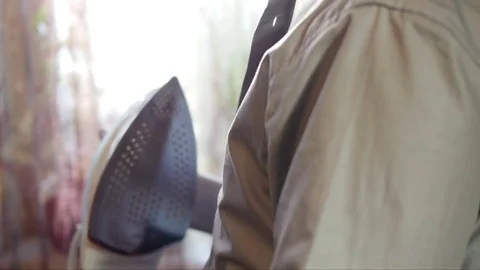 A young man is late for work and the strokes shirt iron on yourself Stock Footage 75627778