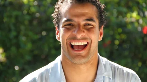 Young man laughing hysterically at camera Video stock 38763376