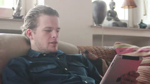 Young man laughs while having a coffee break Stock Footage 40663218