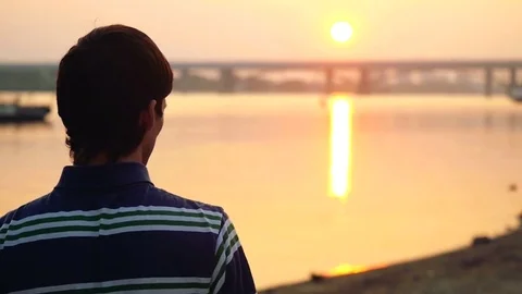 Young man launch paper plane against the sea during amazing sunset with sun Stock Footage 72215728