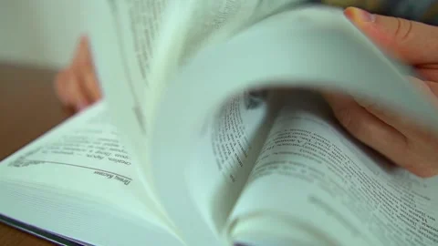 A young man leafing through a book Stock Footage 141363699