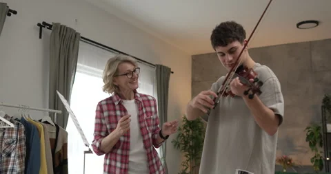 Young man learn how to play violin under instruction mature professor Stock Footage 270090847