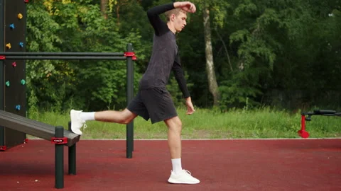 Young man learning to do a Bulgarian split squat with his back foot elevate.. Video stock 341730195