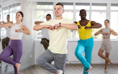 Young man learning dynamic dances at group choreography class Stock Photos