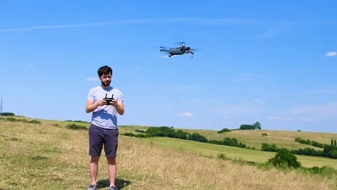 Young man learning to fly a drone Stock Footage 91951011