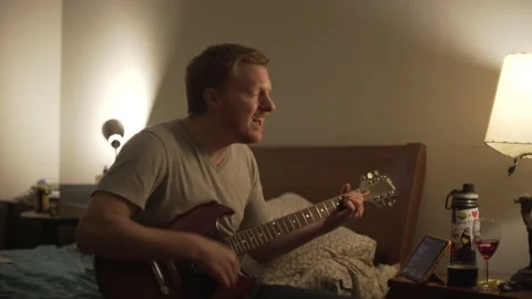 Young Man Learning Guitar Bedroom Evening 1 Stock Footage 149371616