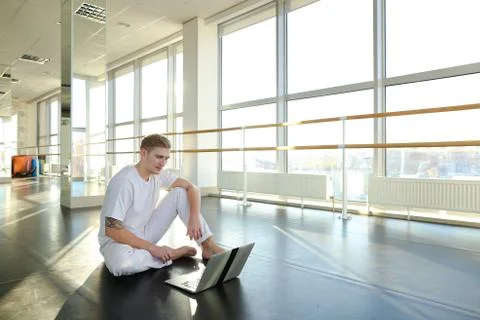 Young man learning new dancing technique with laptop tutorial. Stock Photos