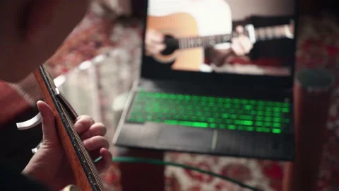 Young man is learning to play the acoustic guitar. remote online lesson. Stock Footage 211812974