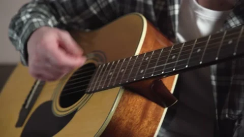 Young man is learn.ing to play the acoustic guitar. online learning. Stock Footage 237986804