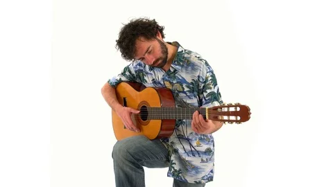 Young Man Learning to Play Classical Guitar and Practicing Stock Footage 76517570