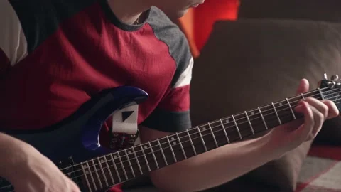 Young man learning to play electric guitar online using laptop. close-up Stock Footage 207783294