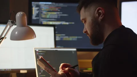 A young man is learning programming on his own while sitting at home. A man Stock Footage 236564329