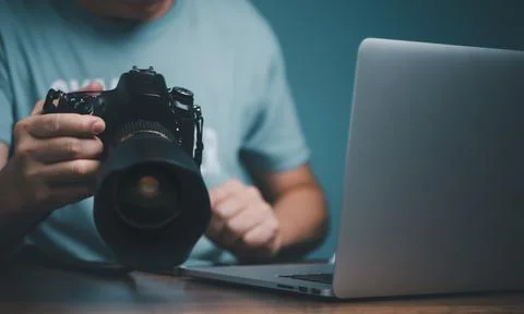 Young man learning to use and setting DSLR camera from video online course.. Stock Photos