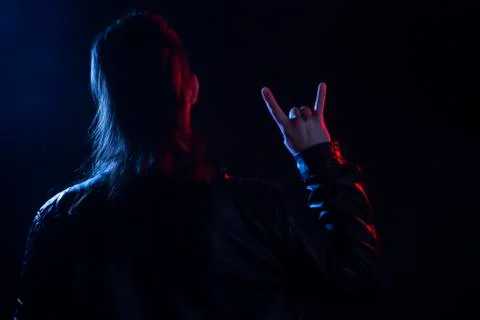Young man with leather jacket making rock gesture 스톡 사진