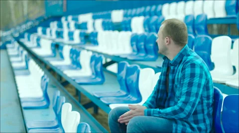 Young man leaving the stadium tribune Stock Footage 63842578