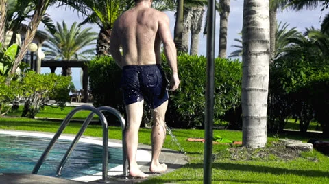 Young man leaving swimming-pool, slow motion shot at 60fps Stock-Footage 25976537