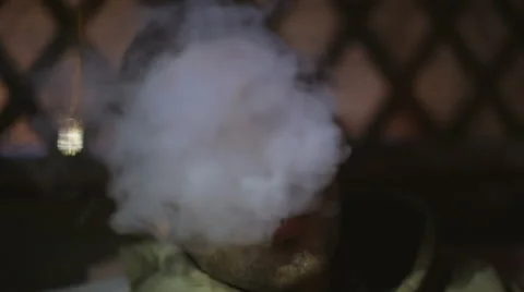 Young man lets out a smoke from a mouth and the camera pulls back Stock Footage 63089950