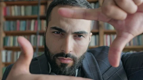 Young Man In The Library Makes Square With His Hands Like Frame And Looks At It. Stock-Footage 140221301