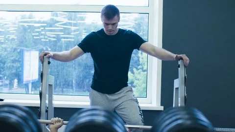 A young man is lifting barbell Video stock 77589085
