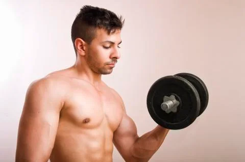 Young man lifting weights Stock Photos