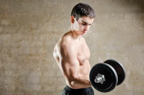 Young man lifting weights Stock Photos