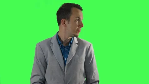 Young man in light gray blazer grabbing invisible objects from both sides Stock Footage 309859240