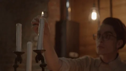 Young man lighting candles Stock Footage 123236390