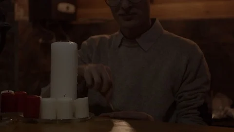 Young man lighting candles Stock Footage 123236661