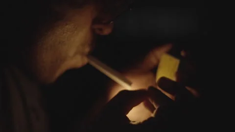 Young Man Lighting Cigarette with Match in Slight Wind - Nighttime Slow Motion Stock Footage 286922801