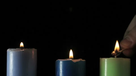 A young man lights a beautiful multi-colored candles Video stock 59099958