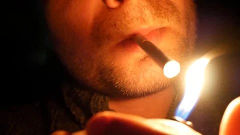 Young man lights a cigarette Stock Footage 113742740