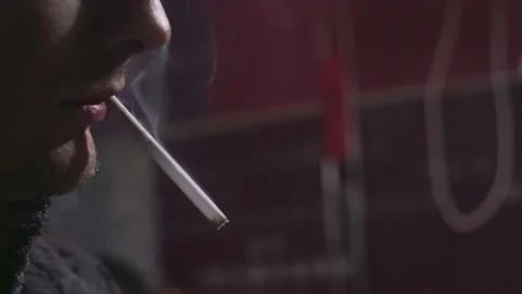 A young man lights cigarette from lighter. Macro close-up profile wiev. Stock Footage 224298890