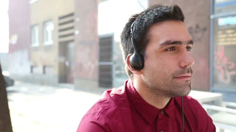 Young man listening to music with headphones Stock Footage 59556389