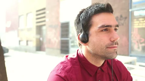 Young man listening to music with headphones Stock Footage 59556393