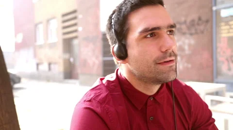 Young man listening to music with headphones Stock Footage 59556405