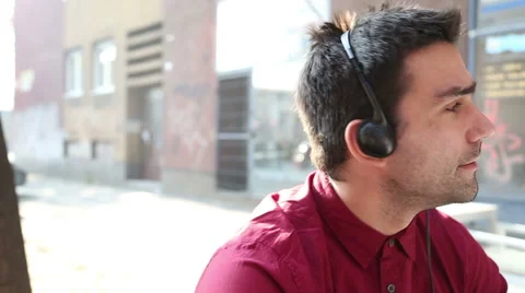 Young man listening to music with headphones Stock Footage 59556406