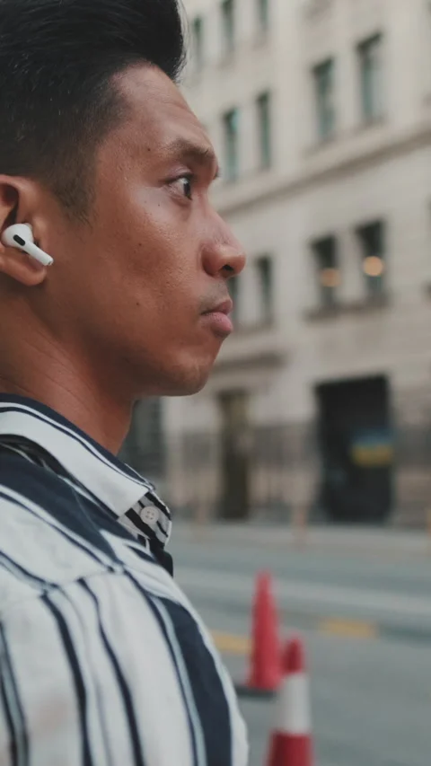 Young man listening to music while standing on crosswalk Video stock 227024706