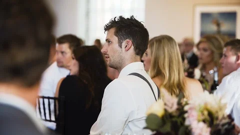 Young man listening to a speech in a crowded wedding venue. Stock Footage 101689661