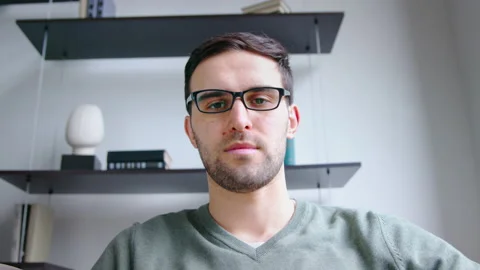 Young man listening by video link in office. Young male looking on webcam video Stock Footage 154398745