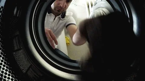 Young man load the washing machine. POV Original point of view Video stock 63850594