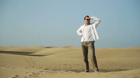 Young man looking around at the desert HD Stock Footage 10901857