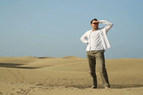 Young man looking around at the desert NTSC Stock Footage 10901859