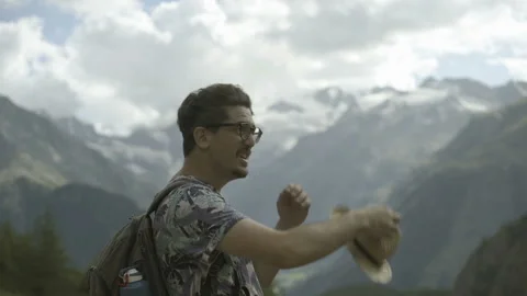 Young Man Looking Around in Mountain Landscape Video stock 138815349